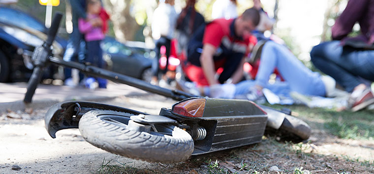 Electric scooter accident victim receiving first aid