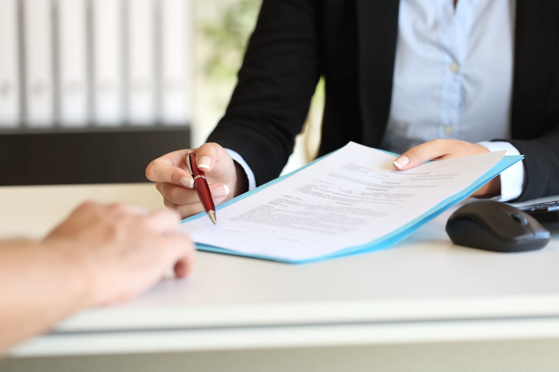 Lawyer Holding Papers and Pen Photo of Lawyer Holding Papers and Pen