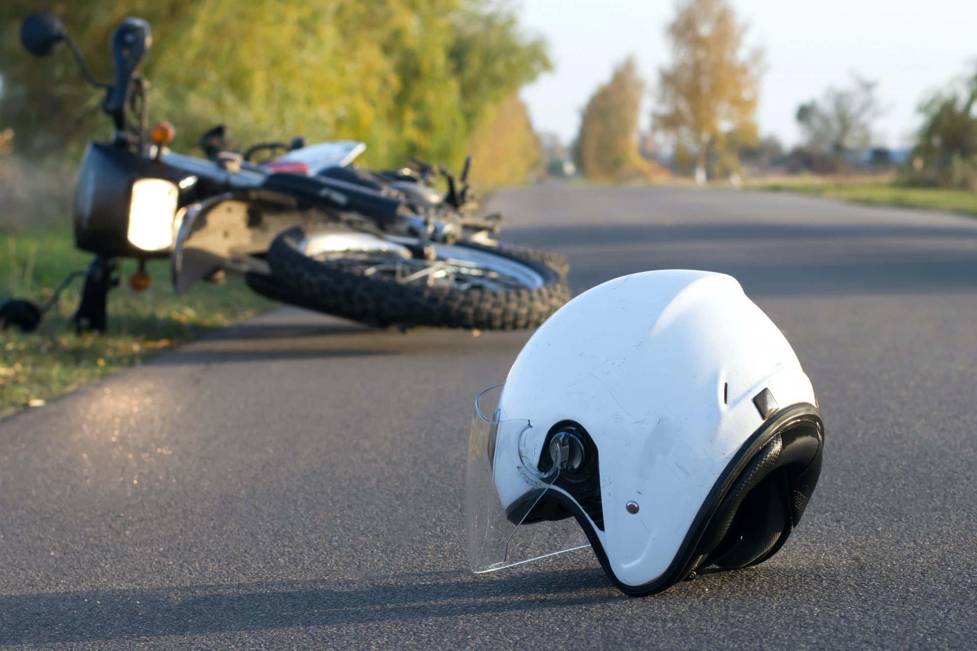 Motorcycle and helmet on the ground after the accident