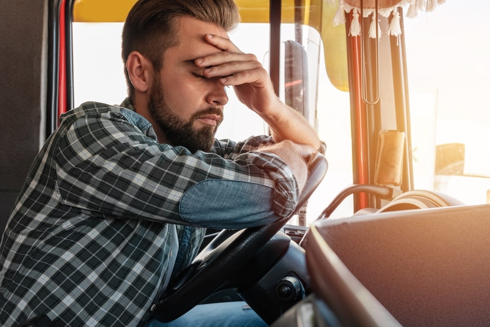 An Upset Truck Driver Holding His Head