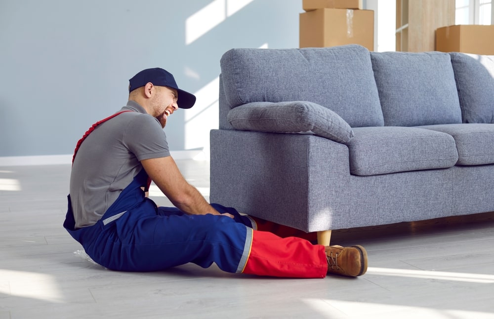 Injured Handyman next to a couch