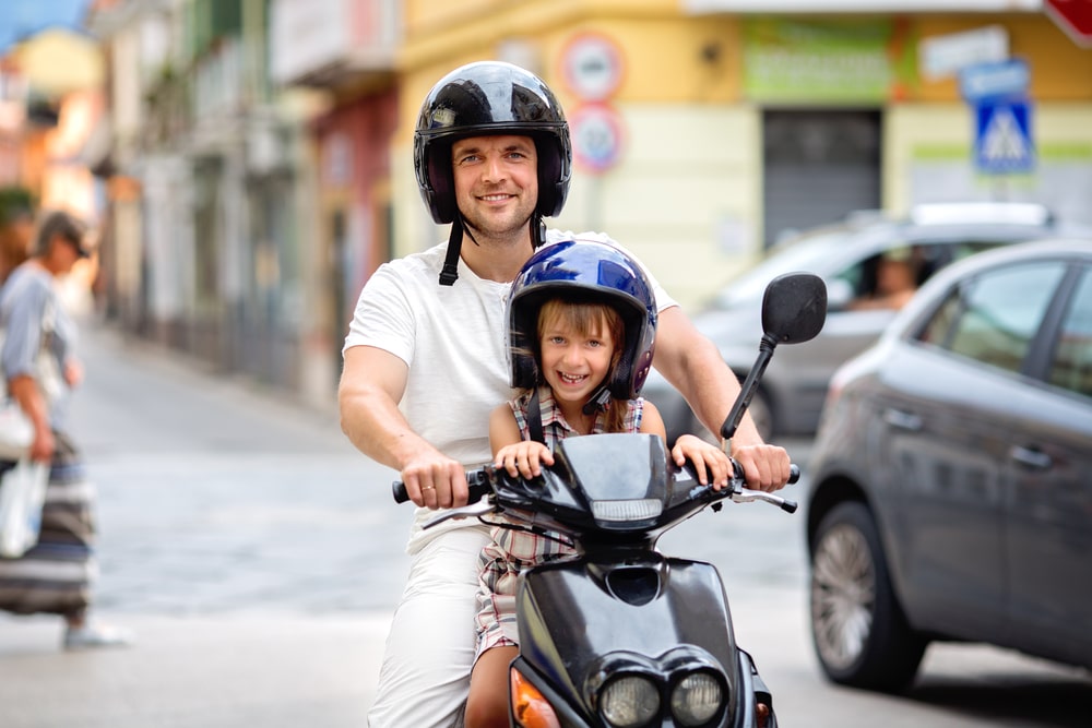 Father And Son Driving A Motorcycle
